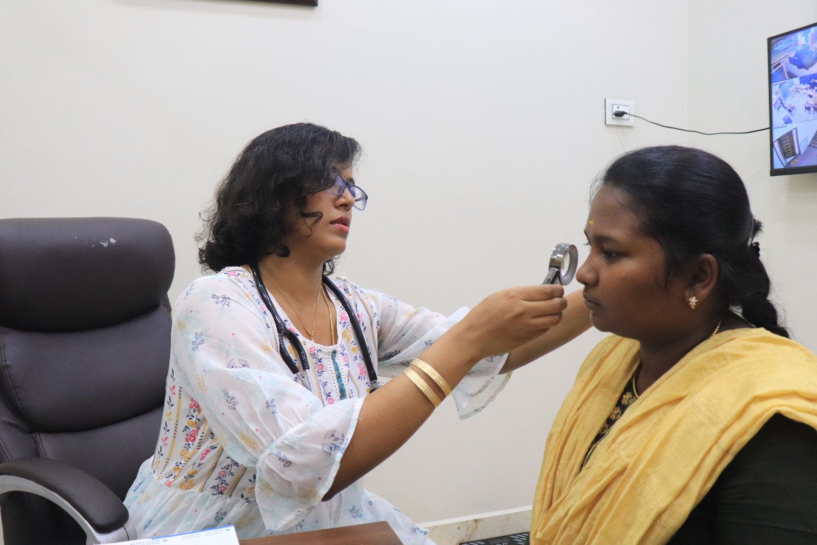 Doctor examining patient with precision skin analysis instrument